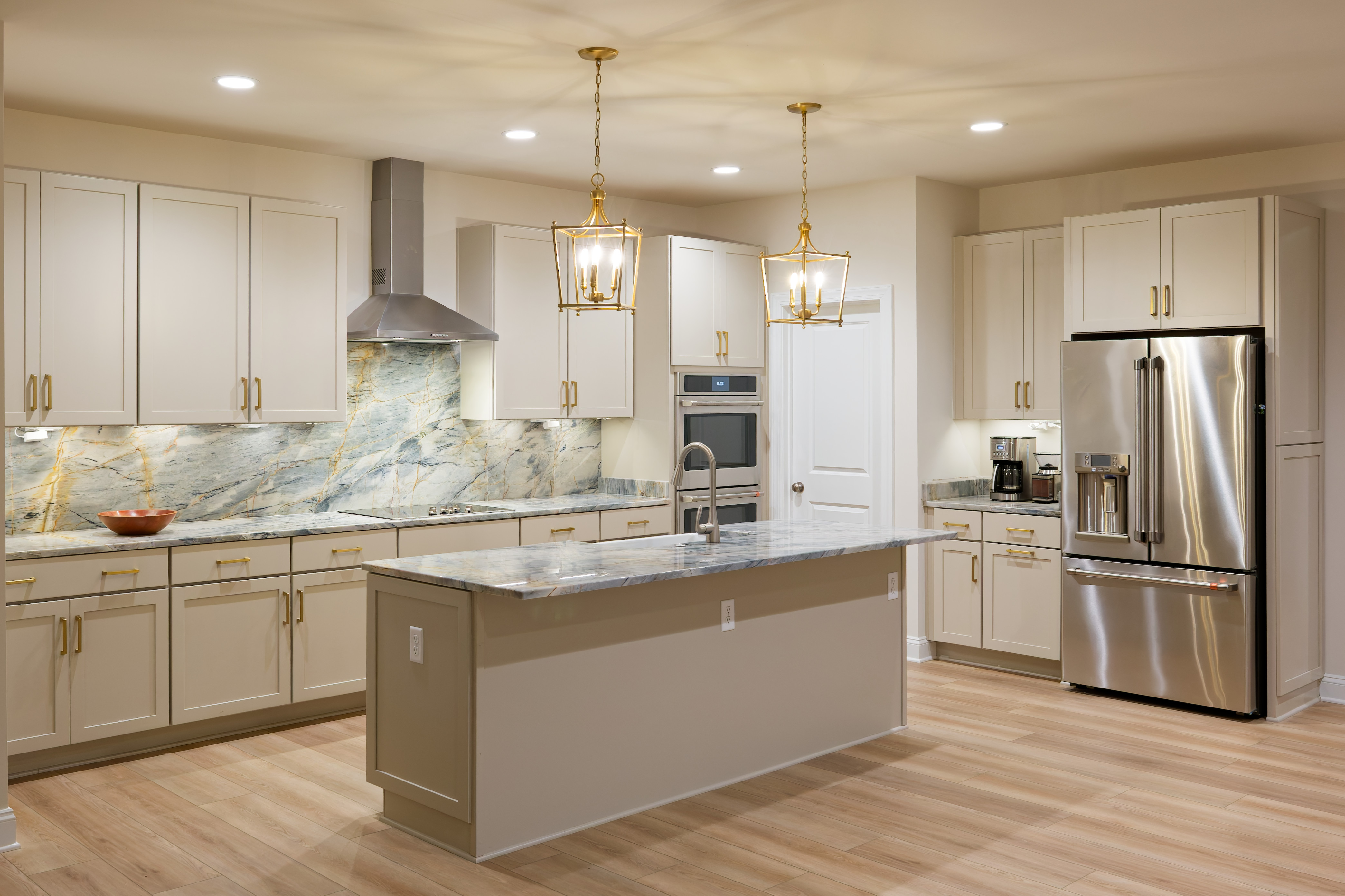 Sweetspire kitchen with a custom stone island and full-height backsplash
